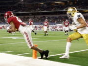 Alabama wide receiver DeVonta Smith (6) catches a pass in the end zone for a touchdown as Notre Dame cornerback Nick McCloud, right, defends in the second half of the Rose Bowl NCAA college football game in Arlington, Texas, Friday, Jan. 1, 2021.