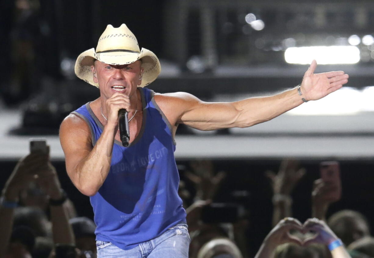 FILE - In this June 23, 2018 file photo, Kenny Chesney performs during the Trip Around the Sun Tour in Phoenix. Chesney&#039;s No Shoes Reefs organization is helping to have an artificial reef installed off of Florida&#039;s Atlantic Coast. The organization and other marine groups donated and installed 13 reef balls on the ocean floor off of Delray Beach in Palm Beach County.