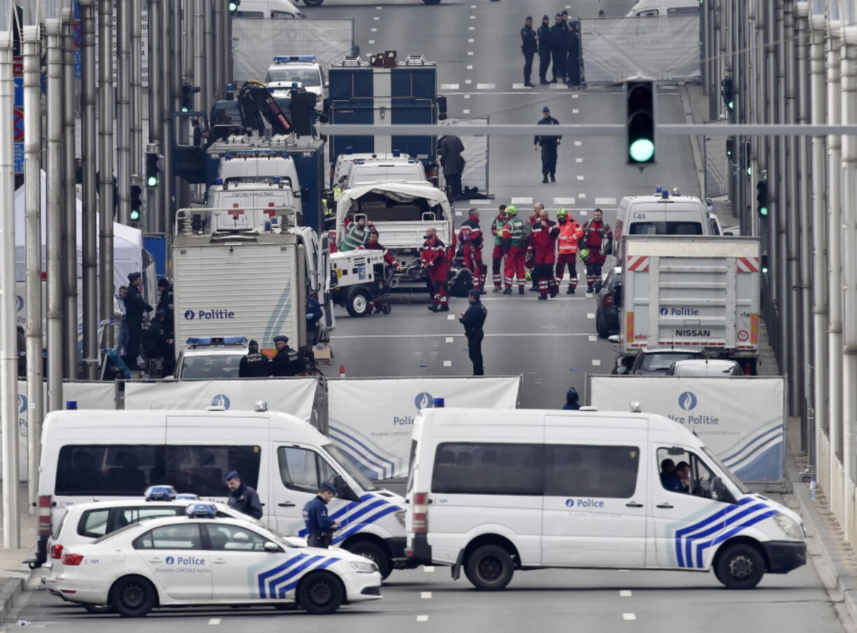 FILE - In this Tuesday, March 22, 2016 file photo, police and rescue teams are pictured outside the metro station Maelbeek in Brussels. On Tuesday Jan 5, 2021, ten people have been ordered to stand trial in connection with the suicide bombings which killed 32 people and injured hundreds in the Brussels subway and airport more than four years ago.