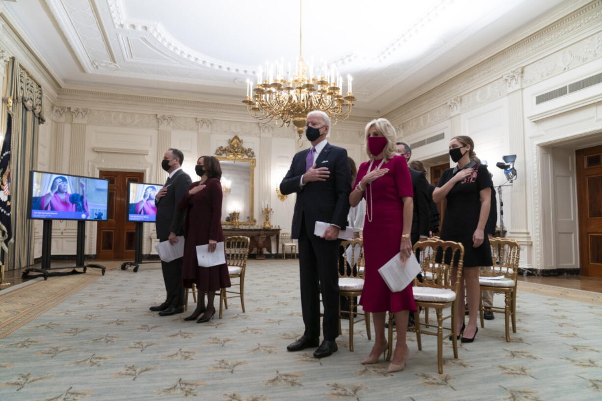 Doug Emhoff, left, Vice President Kamala Harris, President Joe Biden, and first lady Jill Biden, stand during a performance of the national anthem during a virtual Presidential Inaugural Prayer Service, in the State Dinning Room of the White House, Thursday, Jan. 21, 2021, in Washington.