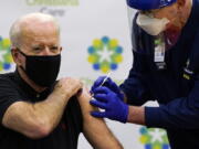 President-elect Joe Biden receives his second dose of the coronavirus vaccine at ChristianaCare Christiana Hospital in Newark, Del., Monday, Jan. 11, 2021. The vaccine is being administered by Chief Nurse Executive Ric Cuming.