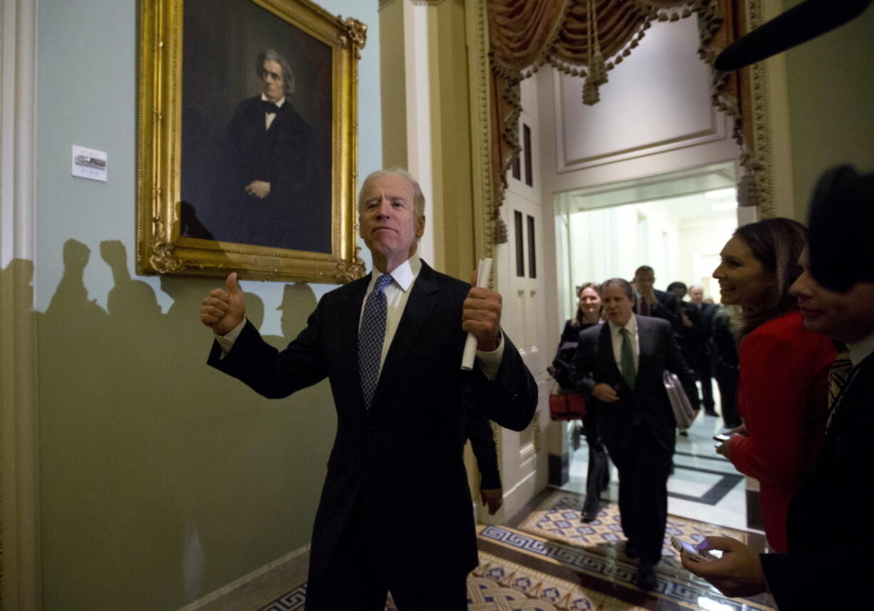 FILE - In this Dec. 31, 2012, file photo Vice President Joe Biden gives two thumbs up following a Senate Democratic caucus meeting about the fiscal cliff on Capitol Hill in Washington.