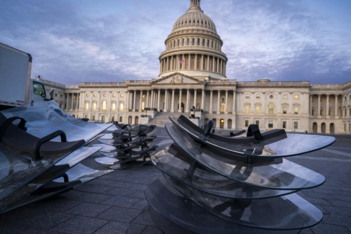 Riot shields are stacked at the ready as National Guard troops reinforce the security zone on Capitol Hill in Washington, Tuesday, Jan. 19, 2021, before President-elect Joe Biden is sworn in as the 46th president on Wednesday. (AP Photo/J.