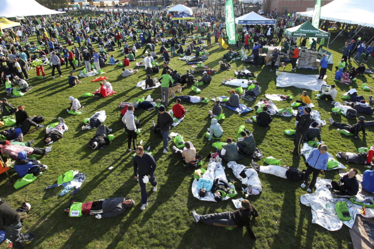 Runners gather at the athletes village prior to the 115th running of the Boston Marathon in 2011 at Hopkinton, Mass. Organizers of the marathon, postponed indefinitely because of the coronavirus pandemic, have launched a virtual Athletes&#039; Village in 2020 to reproduce at least some of the camaraderie of the real thing.