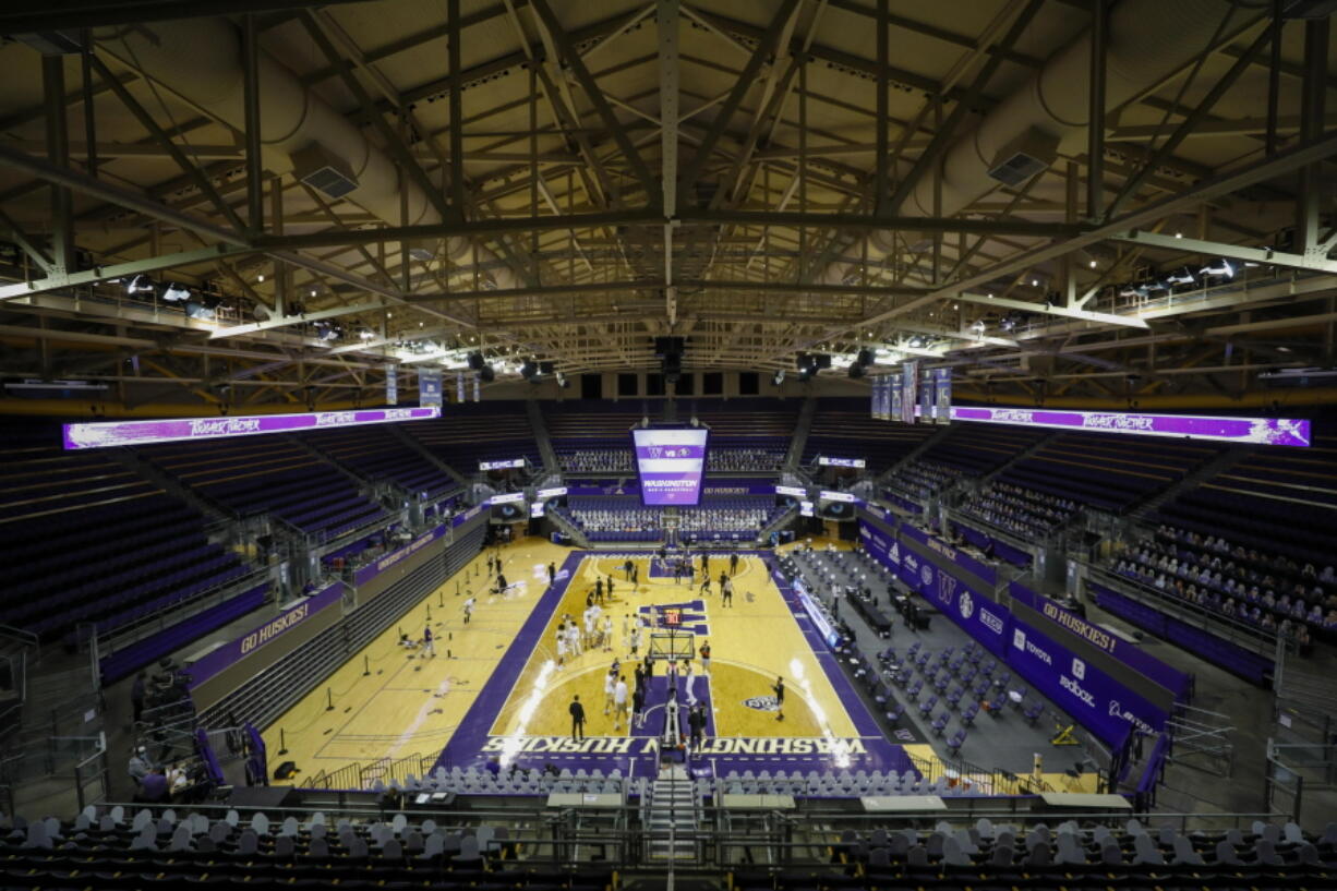 Players warm up for an NCAA college basketball game between Colorado and Washington on Wednesday, Jan. 20, 2021, in Seattle.