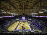 Players warm up for an NCAA college basketball game between Colorado and Washington on Wednesday, Jan. 20, 2021, in Seattle.