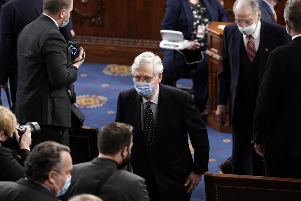 Senate Majority Leader Mitch McConnell, R-Ky., leaves the House chamber for the Senate to consider objections to certify Electoral College votes, at the Capitol in Washington, Wednesday, Jan. 6, 2021. (AP Photo/J.