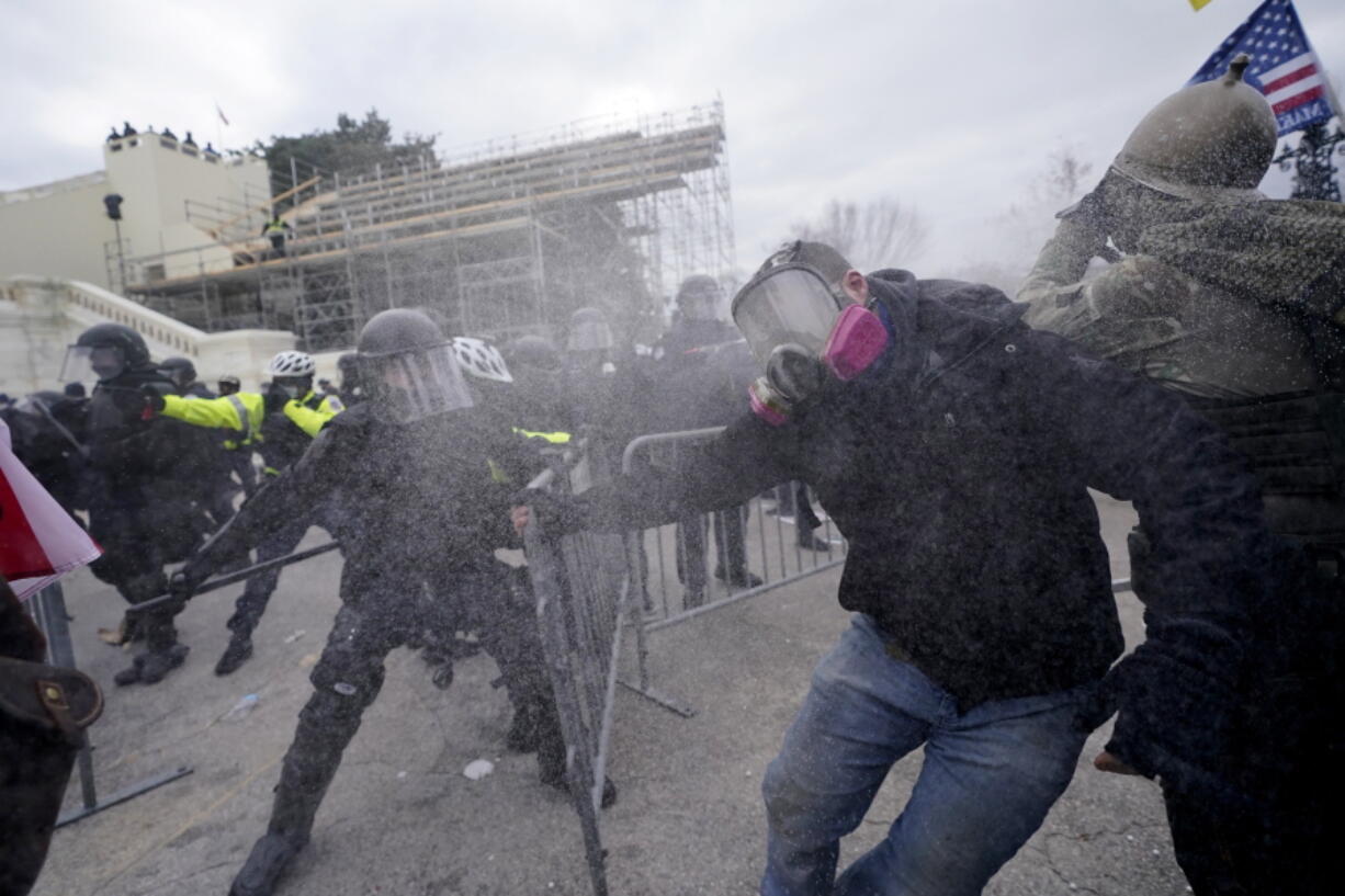 Trump supporters try to break through a police barrier, Wednesday, Jan. 6, 2021, at the Capitol in Washington.