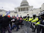 Trump supporters try to break through a police barrier, Wednesday, Jan. 6, 2021, at the Capitol in Washington.