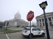 A Washington State Patrol vehicle patrols Thursday, Jan. 7, 2021, at the Capitol in Olympia. (AP Photo/Ted S.