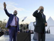 President-elect Joe Biden, right, campaigns Jan. 4 for Senate candidates Raphael Warnock, left, and Jon Ossoff, not pictured, in Atlanta.