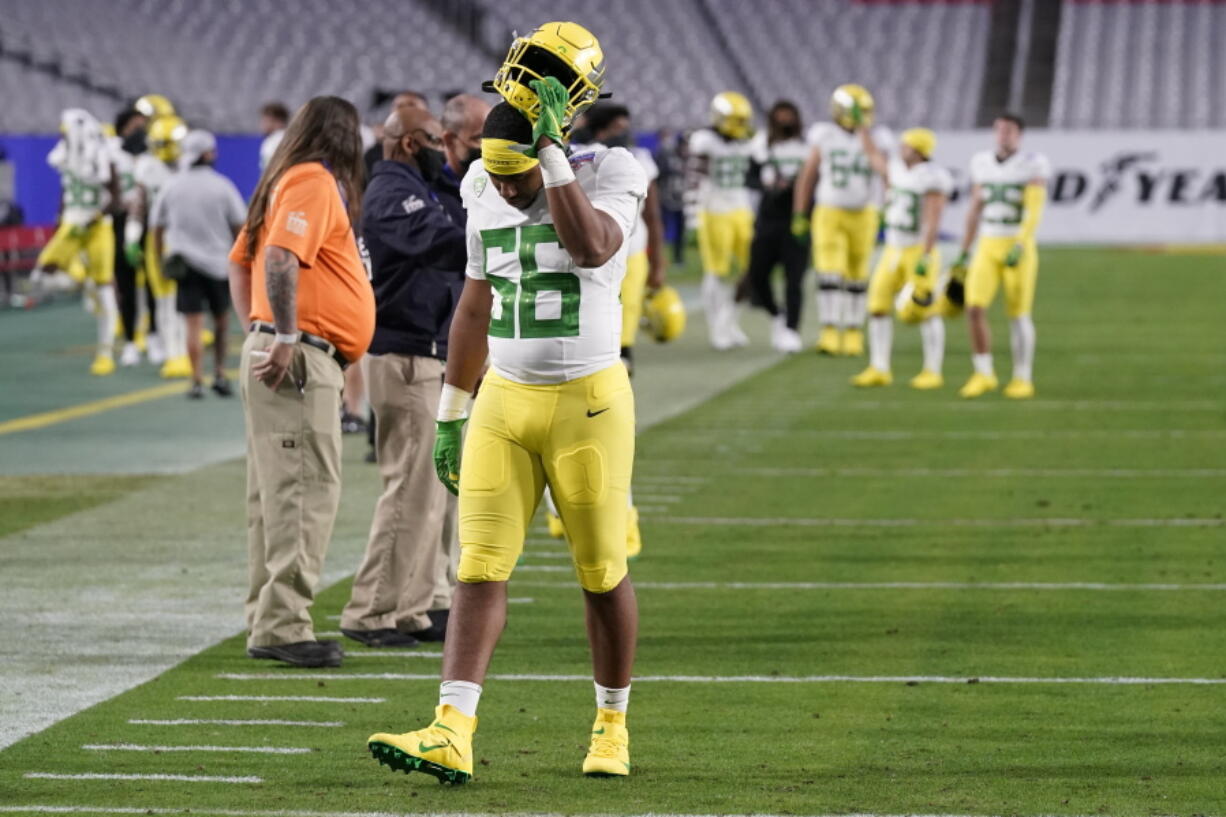 Oregon linebacker TJ Gilbert (56) leaves the field after the Fiesta Bowl NCAA college football game against Oregon, Saturday, Jan. 2, 2021, in Glendale, Ariz. Iowa State won 34-17. (AP Photo/Ross D.