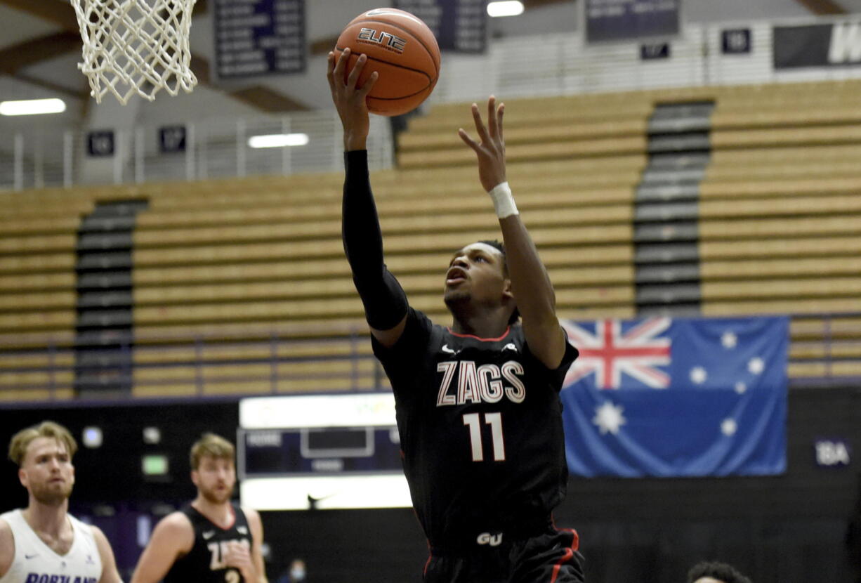 Gonzaga University guard Joel Ayayi, drives to the basket during the first half of an NCAA college basketball game against Portland in Portland, Ore., Saturday, Jan. 9, 2021.