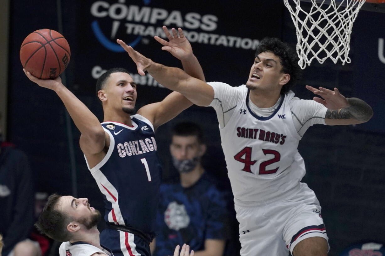 Gonzaga guard Jalen Suggs (1) shoots against Saint Mary&#039;s forward Dan Fotu (42) during the second half of an NCAA college basketball game in Moraga, Calif., Saturday, Jan. 16, 2021.