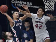 Gonzaga guard Jalen Suggs (1) shoots against Saint Mary&#039;s forward Dan Fotu (42) during the second half of an NCAA college basketball game in Moraga, Calif., Saturday, Jan. 16, 2021.