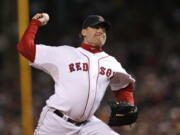 FILE - In this Oct. 25, 2007, file photo, Boston Red Sox&#039;s Curt Schilling pitches against the Colorado Rockies in Game 2 of the baseball World Series at Fenway Park in Boston. Like many baseball writers, C. Trent Rosecrans viewed the Hall of Fame vote as a labor of love. The results of the 2021 vote will be announced Tuesday, Jan. 26, 2021, and Rosecrans was not alone in finding the task particularly agonizing this time around. With Schilling&#039;s candidacy now front and center -- and Barry Bonds and Roger Clemens still on the ballot as well -- voters have had to consider how much a player&#039;s off-field behavior should affect his Hall of Fame chances.