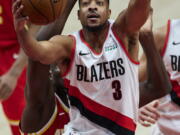 Portland Trail Blazers guard CJ McCollum shoots against the Atlanta Hawks during the first half of an NBA basketball game in Portland, Ore., Saturday, Jan. 16, 2021.