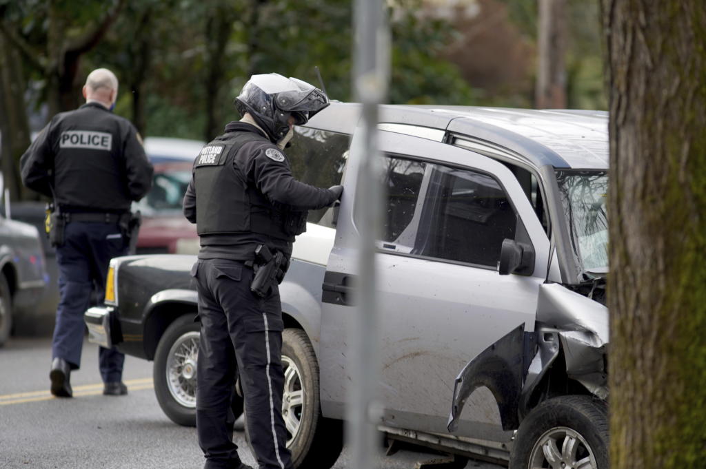 Police investigate after a driver struck and injured at least five people over a 20-block stretch of Southeast Portland, Ore., before crashing and fleeing on Monday, Jan. 25, 2021, according to witnesses.