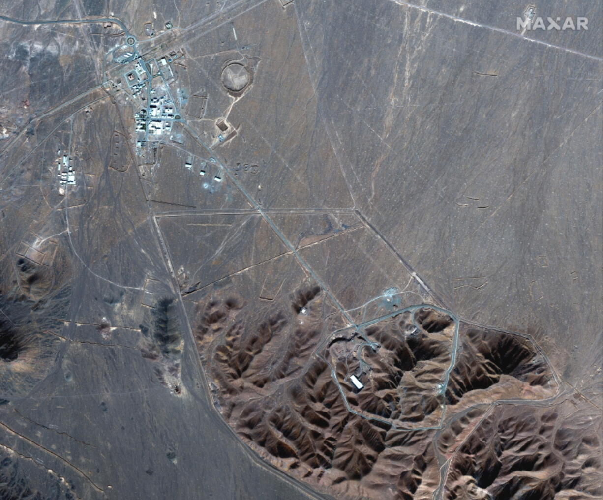 FILE - This Nov. 4, 2020, file satellite photo by Maxar Technologies shows Iran&#039;s Fordo nuclear site. Iran has told international nuclear inspectors it plans to enrich uranium up to 20% at its underground Fordo nuclear facility, a technical step away from weapons-grade levels, as it increases pressure on the West over its tattered atomic deal.