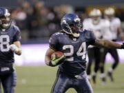 Seattle Seahawks&#039; Marshawn Lynch begins to celebrate after a 67-yard touchdown run against the New Orleans Saints on Jan. 8, 2011, in Seattle.