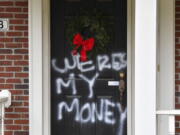 Graffiti reading, &quot;Where&#039;s my money&quot; is seen on a door of the home of Senate Majority Leader Mitch McConnell, R-Ky., in Louisville, Ky., on Saturday, Jan. 2, 2021. As of Saturday morning, messages like &quot;where&#039;s my money&quot; and other expletives were written with spray paint across the front door and bricks of the Kentucky Republican&#039;s Highlands residence.    (AP Photo/Timothy D.