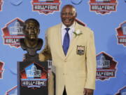 Floyd Little poses with his bust after enshrinement in the Pro Football Hall of Fame in 2010 at Canton, Ohio. Little, the Hall of Fame running back who starred at Syracuse and for the Denver Broncos, has died at age 78. The Pro Football Hall of Fame said he died Friday, Jan. 1, 2021.