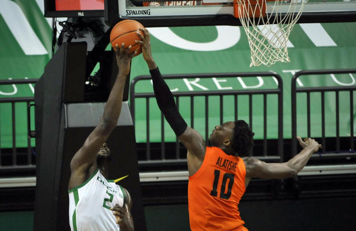 Oregon State forward Warith Alatishe (10) blocks the shot of Oregon forward Eugene Omoruyi (2) during the first half of an NCAA college basketball game Saturday, Jan. 23, 2021, in Eugene, Ore.