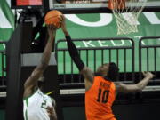 Oregon State forward Warith Alatishe (10) blocks the shot of Oregon forward Eugene Omoruyi (2) during the first half of an NCAA college basketball game Saturday, Jan. 23, 2021, in Eugene, Ore.