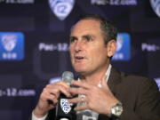 FILE - In this Oct. 7, 2019, file photo, Pac-12 Commissioner Larry Scott speaks to reporters during the Pac-12 Conference women&#039;s NCAA college basketball media day in San Francisco. Scott is stepping down at the end of June 2021, ending an 11-year tenure in which the conference landed a transformational billion dollar television deal but struggled to keep up with some of its Power Five peers when it came to revenue and exposure. (AP Photo/D.