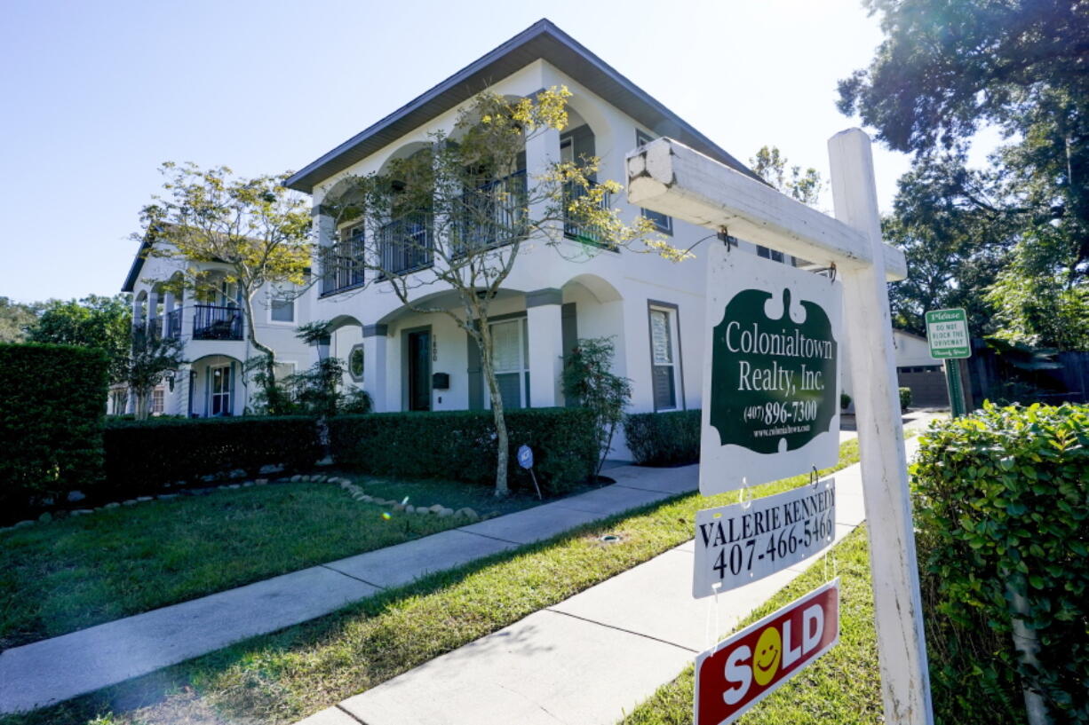 This Dec. 8, 2020 photo shows a sold home in Orlando, Fla.  The number of Americans who signed contracts to buy homes declined slightly for the fourth straight month, but it was still a record high for December. The National Association of Realtors said Friday , Jan. 29, 2021, that its index of pending sales dipped 0.3% to 125.5 in December, an all-time high.