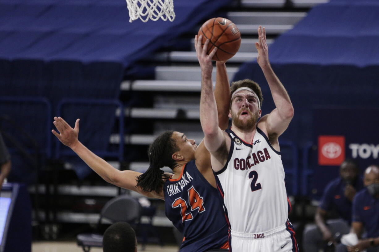 Gonzaga forward Drew Timme (2) shoots while pressured by Pepperdine forward Kene Chukwuka (24) during the first half of an NCAA college basketball game in Spokane, Wash., Thursday, Jan. 14, 2021.