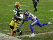 Green Bay Packers quarterback Aaron Rodgers scores on a one-yard touchdown run past Los Angeles Rams&#039; John Johnson during the first half of an NFL divisional playoff football game, Saturday, Jan. 16, 2021, in Green Bay, Wis.