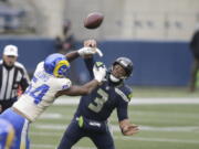 Los Angeles Rams outside linebacker Leonard Floyd (54) knocks the ball away as Seattle Seahawks quarterback Russell Wilson tries to pass during the first half of an NFL wild-card playoff football game, Saturday, Jan. 9, 2021, in Seattle.