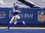 Buffalo Bills&#039; Taron Johnson (24) returns an interception for a touchdown during the second half of an NFL divisional round football game against the Baltimore Ravens Saturday, Jan. 16, 2021, in Orchard Park, N.Y.