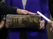 FILE - In this Sunday, Jan. 20, 2013 file photo, Vice President Joe Biden, left, places his hand on the Biden family Bible held by his wife, Jill Biden, center, as he takes the oath of office from Supreme Court Justice Sonia Sotomayor, right, during an official ceremony at the Naval Observatory in Washington. While many presidents have used Bibles for their inaugurations, the Constitution does not require the use of a specific text and specifies only the wording of president&#039;s oath. That wording also doesn&#039;t include the phrase &quot;so help me God,&quot; but every modern president has appended it to their oaths and most have chosen symbolically resonant Bibles for their inaugurations.