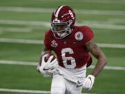 Alabama wide receiver DeVonta Smith (6) gains yardage after a catch in the first half of the Rose Bowl NCAA college football game against Notre Dame in Arlington, Texas, Friday, Jan. 1, 2021.