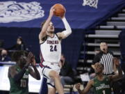 Gonzaga forward Corey Kispert (24) shoots between San Francisco forward Josh Kunen (10) and guard Jamaree Bouyea (1) during the first half of an NCAA college basketball game in Spokane, Wash., Saturday, Jan. 2, 2021.