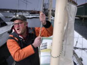 Bennett Konesni sings a sea shanty while raising a sail on his ketch, Thursday, Jan. 28, 2021, in Belfast, Maine. Konesni started singing sea shanties aboard a schooner in Penobscot Bay and has since traveled the world studying work songs. The app TikTok helped sea shanties surge into the mainstream. (AP Photo/Robert F.