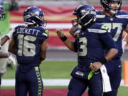 Seattle Seahawks wide receiver Tyler Lockett (16) celebrates his touchdown with quarterback Russell Wilson (3) during the second half of an NFL football game against the San Francisco 49ers, Sunday, Jan. 3, 2021, in Glendale, Ariz. (AP Photo/Ross D.