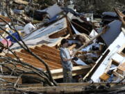 James Scott, 19, pauses while picking through the remains of his home, which was destroyed by a tornado, on Tuesday, Jan. 26, 2021, in Fultondale, Ala. Scott, who survived with his mother and sister, had never lived anywhere else and isn&#039;t sure where he will wind up after the storm.