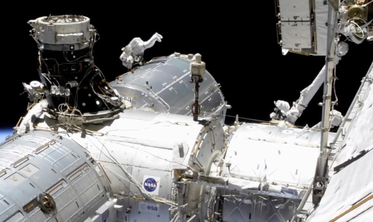 In this image taken from NASA video, NASA astronaut Mike Hopkins works outside the International Space Station&#039;s European lab on Wednesday, Jan. 27, 2021. Hopkins and Victor Glover went spacewalking Wednesday to install a high-speed data link outside the International Space Station&#039;s European lab and connect cables for an experiment platform awaiting activation for almost a year.