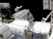 In this image taken from NASA video, NASA astronaut Mike Hopkins works outside the International Space Station&#039;s European lab on Wednesday, Jan. 27, 2021. Hopkins and Victor Glover went spacewalking Wednesday to install a high-speed data link outside the International Space Station&#039;s European lab and connect cables for an experiment platform awaiting activation for almost a year.