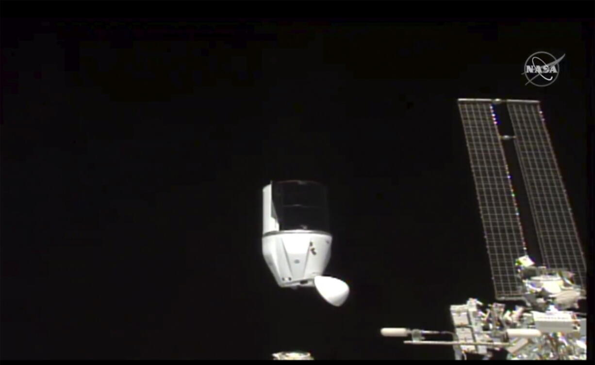 This photo provided by NASA shows SpaceX&#039;s Dragon undocking from International Space Station on Tuesday, Jan. 12, 2021.  SpaceX&#039;s Dragon cargo capsule undocked with 12 bottles of Bordeaux wine and hundreds of snippets of Merlot and Cabernet Sauvignon vines. The capsule is aiming for a splashdown in the Gulf of Mexico off the Florida coast Wednesday night.
