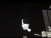 This photo provided by NASA shows SpaceX&#039;s Dragon undocking from International Space Station on Tuesday, Jan. 12, 2021.  SpaceX&#039;s Dragon cargo capsule undocked with 12 bottles of Bordeaux wine and hundreds of snippets of Merlot and Cabernet Sauvignon vines. The capsule is aiming for a splashdown in the Gulf of Mexico off the Florida coast Wednesday night.