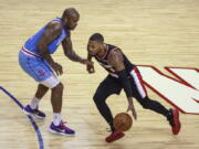 Portland Trail Blazers guard Damian Lillard (0) drives against Houston Rockets forward P.J. Tucker (17) during the first quarterof an NBA basketball game Thursday, Jan. 28, 2021, in Houston.