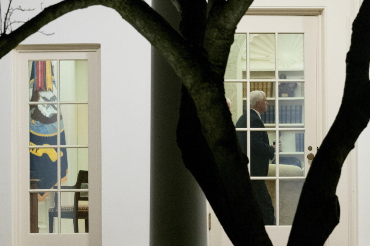 Vice President Mike Pence walks through the Oval Office before President Donald Trump departs the White House in Washington, Monday, Jan. 4, 2021, for a short trip to Andrews Air Force Base, Md., and then on to Dalton, Ga. for a rally.