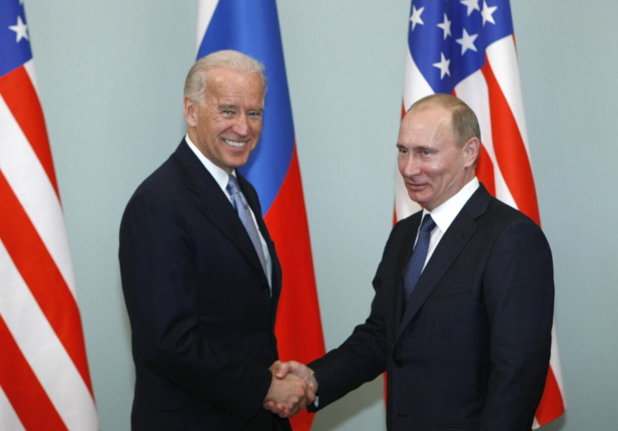 FILE - In this March 10, 2011, file photo, then-Vice President Joe Biden, left, shakes hands with Russian Prime Minister Vladimir Putin in Moscow, Russia.  President Joe Biden has been thrown into a high-wire act with Russia as he seeks to toughen his administration&#039;s stance against Putin while preserving room for diplomacy in a post-Donald Trump era.