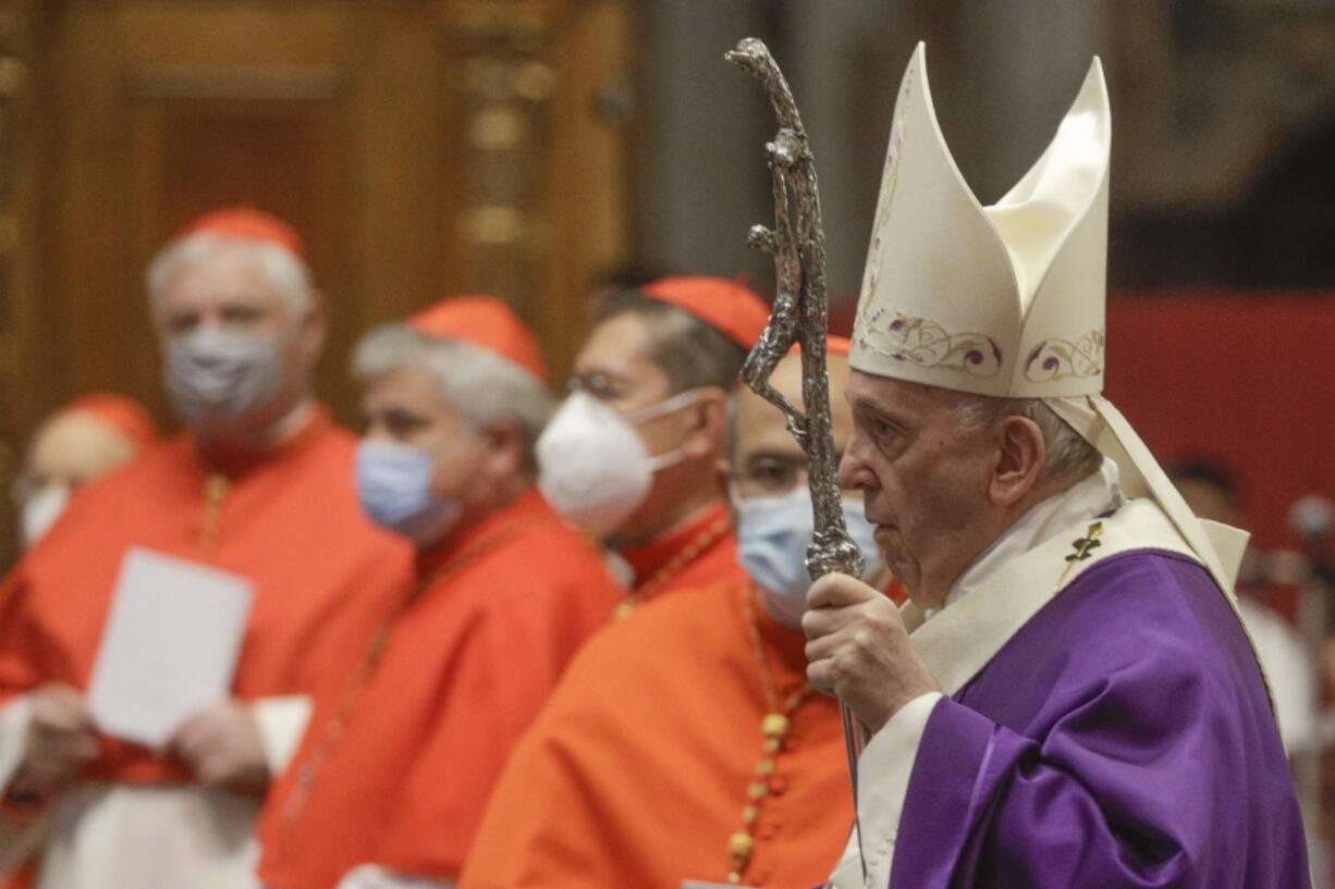 FILE - In this file photo dated  Sunday, Nov. 29, 2020, Pope Francis holds his pastoral staff as he arrives to celebrate Mass, at St. Peter&#039;s Basilica.  Pope Francis has changed church law to explicitly allow women to do more things during Mass, Monday Jan. 11, 2021, while reaffirming they cannot be priests.