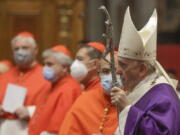 FILE - In this file photo dated  Sunday, Nov. 29, 2020, Pope Francis holds his pastoral staff as he arrives to celebrate Mass, at St. Peter&#039;s Basilica.  Pope Francis has changed church law to explicitly allow women to do more things during Mass, Monday Jan. 11, 2021, while reaffirming they cannot be priests.