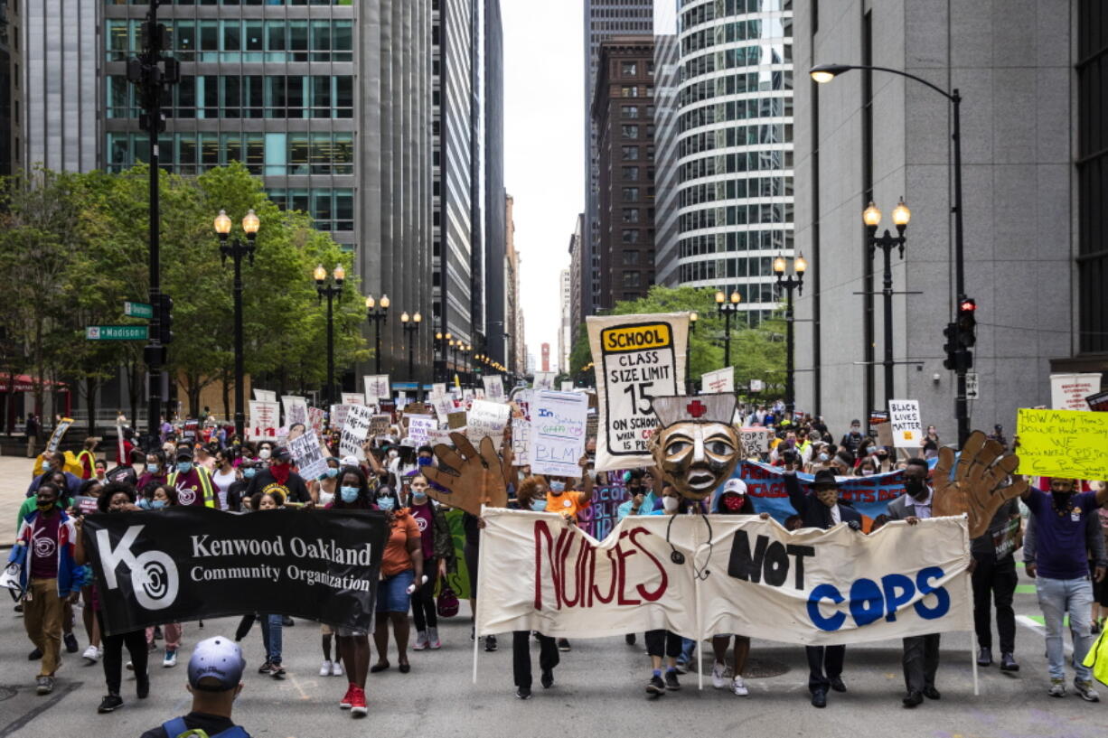 Chicago Teachers Union members and hundreds of supporters march through the Loop, Wednesday, June 24, 2020. The Chicago Teachers Union said Sunday, Jan. 24, 2021 that its members voted to defy an order to return to the classroom over concerns about COVID-19, setting up a showdown with district officials who have said such a move would amount to an illegal strike.